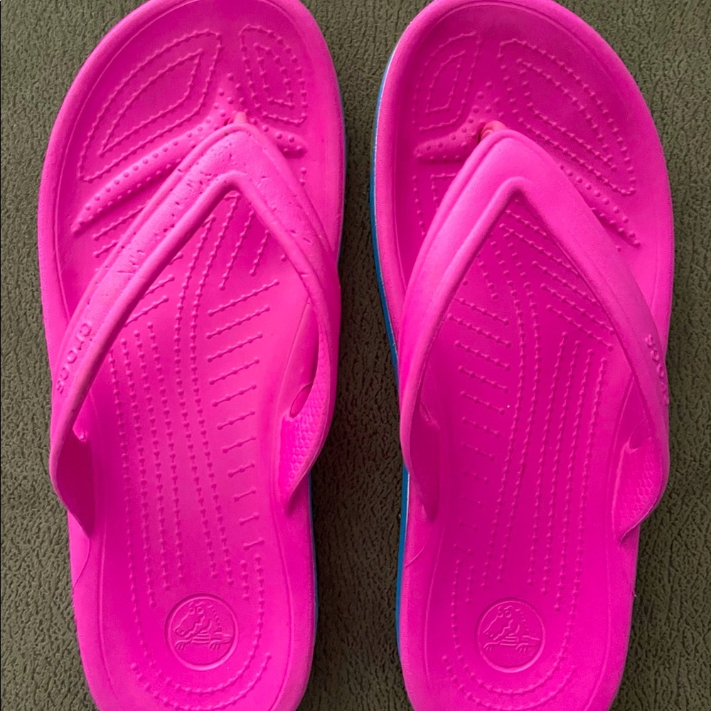 Crocs pink and blue flip flops